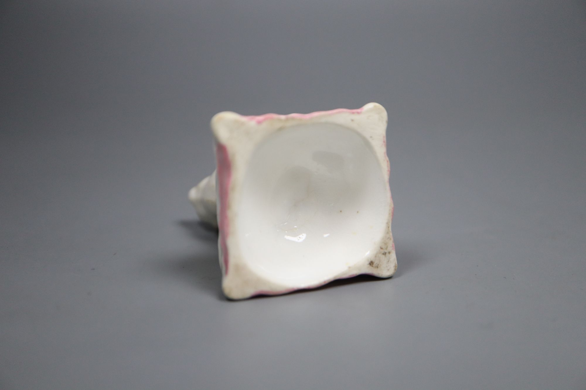 A rare Staffordshire porcelain figure of a cat seated on a cushion, c.1835-50, 6cm